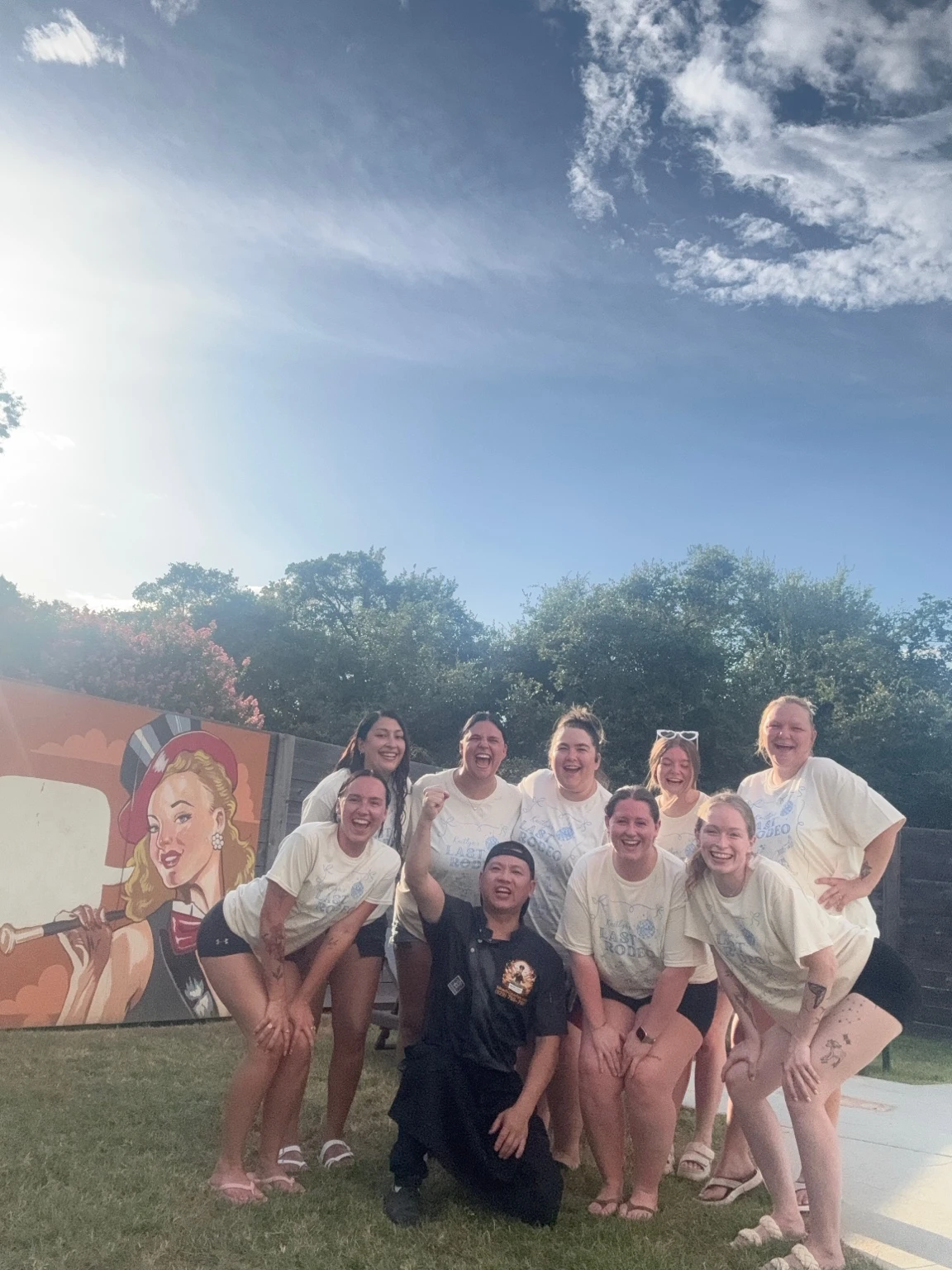 Chef and guests smiling together at an outdoor hibachi celebration
